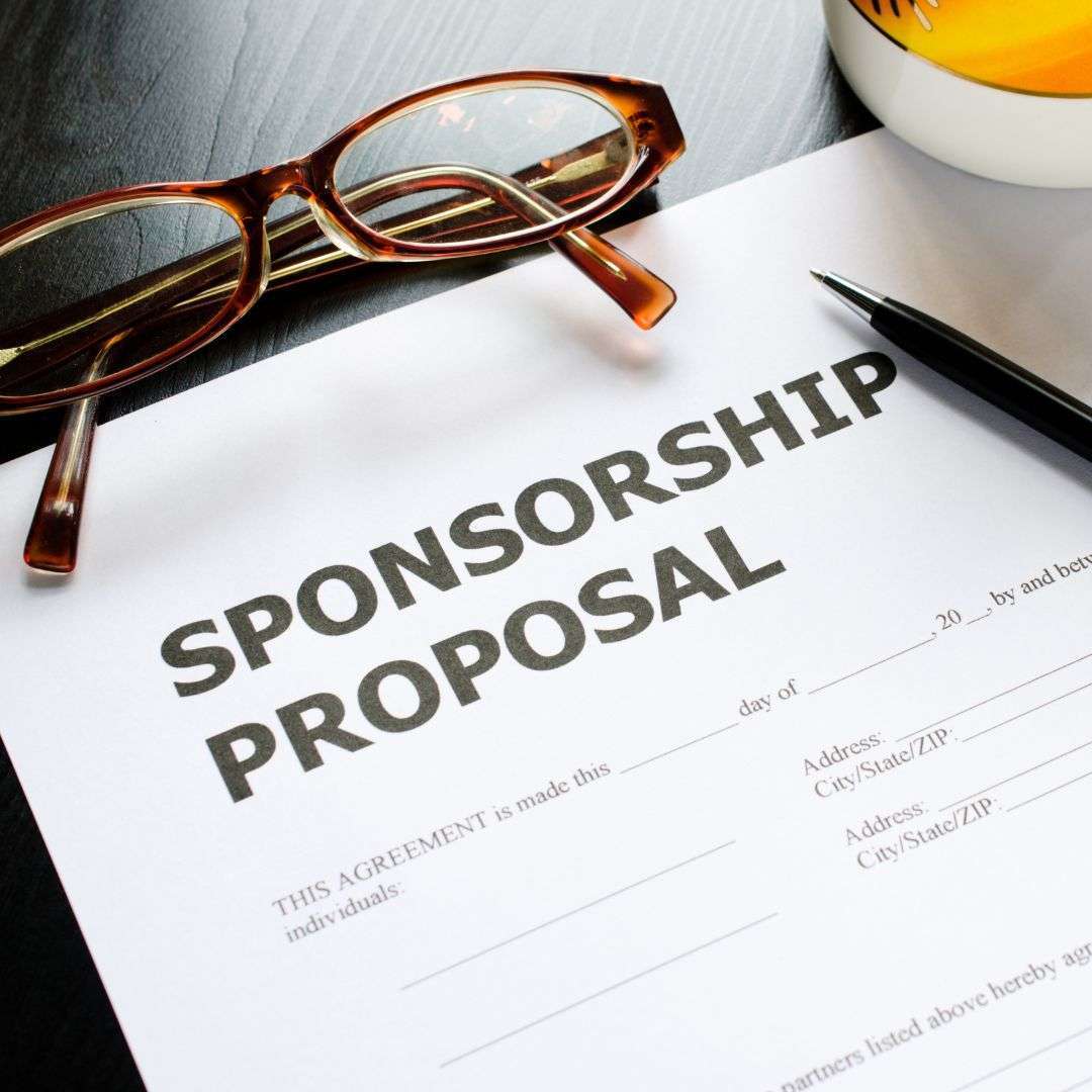 Sponsorship proposal document on a table with glasses and a pen, emphasizing change management sponsorship strategies.