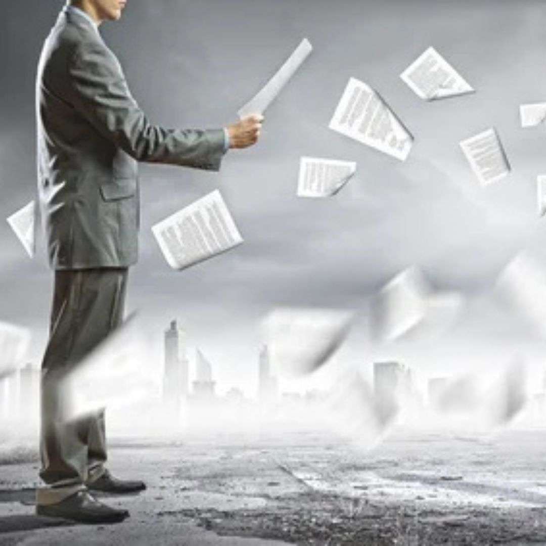 Businessman holding documents in a windy urban environment, symbolizing the challenges of transformational change and sponsor contracting.